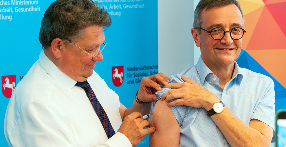 Der Präsident des NLGA Dr. Fabian Feil wird von Gesundheitsminister Dr. Andreas Philippi gegen Influenza geimpft.